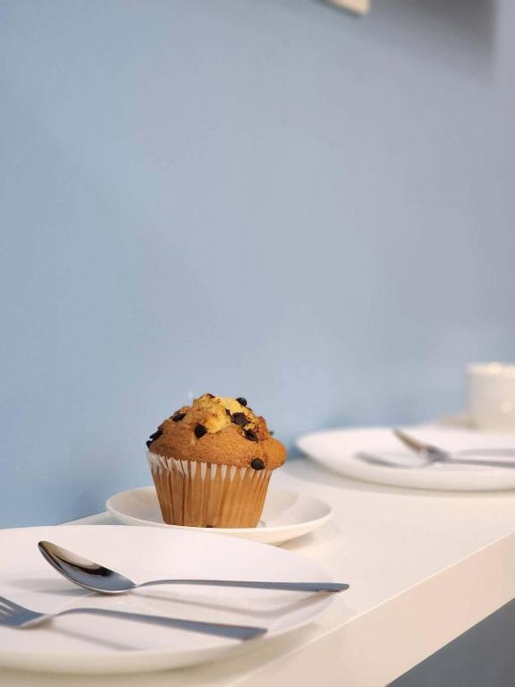 a muffin sitting on a plate on a table at 438 Shore Residences tower B - MOA in Sampong