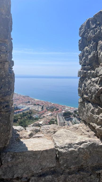 a view of a city from a rocky mountain at Santa Maria do Castelo in Sesimbra
