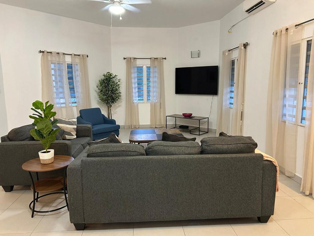 a living room with a couch and a flat screen tv at Luxury 3BR Villa Belair in Philipsburg