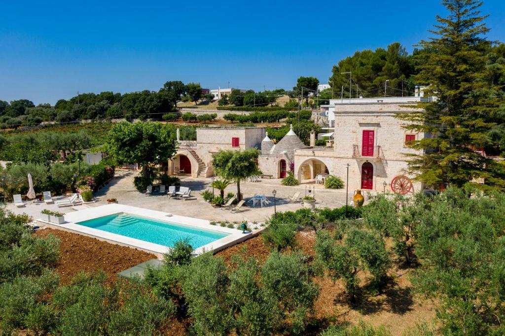 an aerial view of a house with a swimming pool at Masseria Trulli Bruni in Locorotondo
