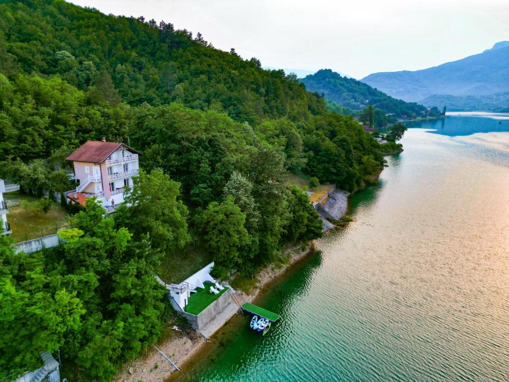 an island in the middle of a river with a house at Golden Lake House in Konjic