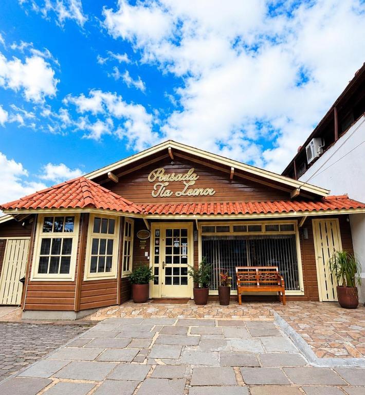 a building with a sign on top of it at Pousada Tia Leonor in Gramado