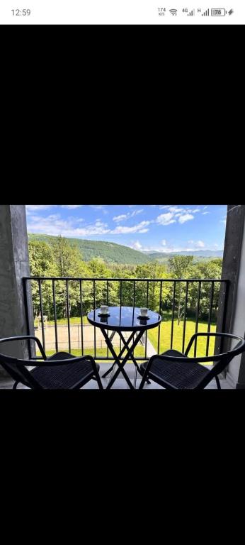 a table and chairs on a balcony with a view at Kechi home 6 in Tsaghkadzor