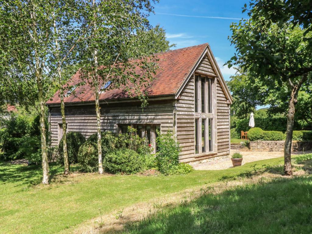 an old wooden house with a yard at The Barn at Frog Pond Farm in Salisbury