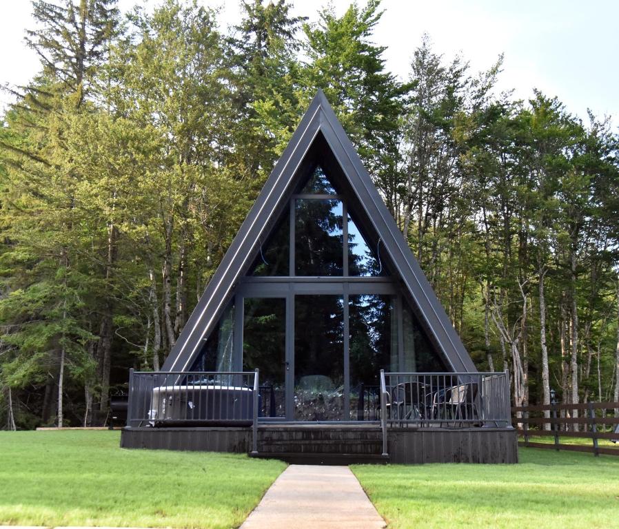 a frame house with a window in the grass at Magic Forest Durmitor in Motički Gaj