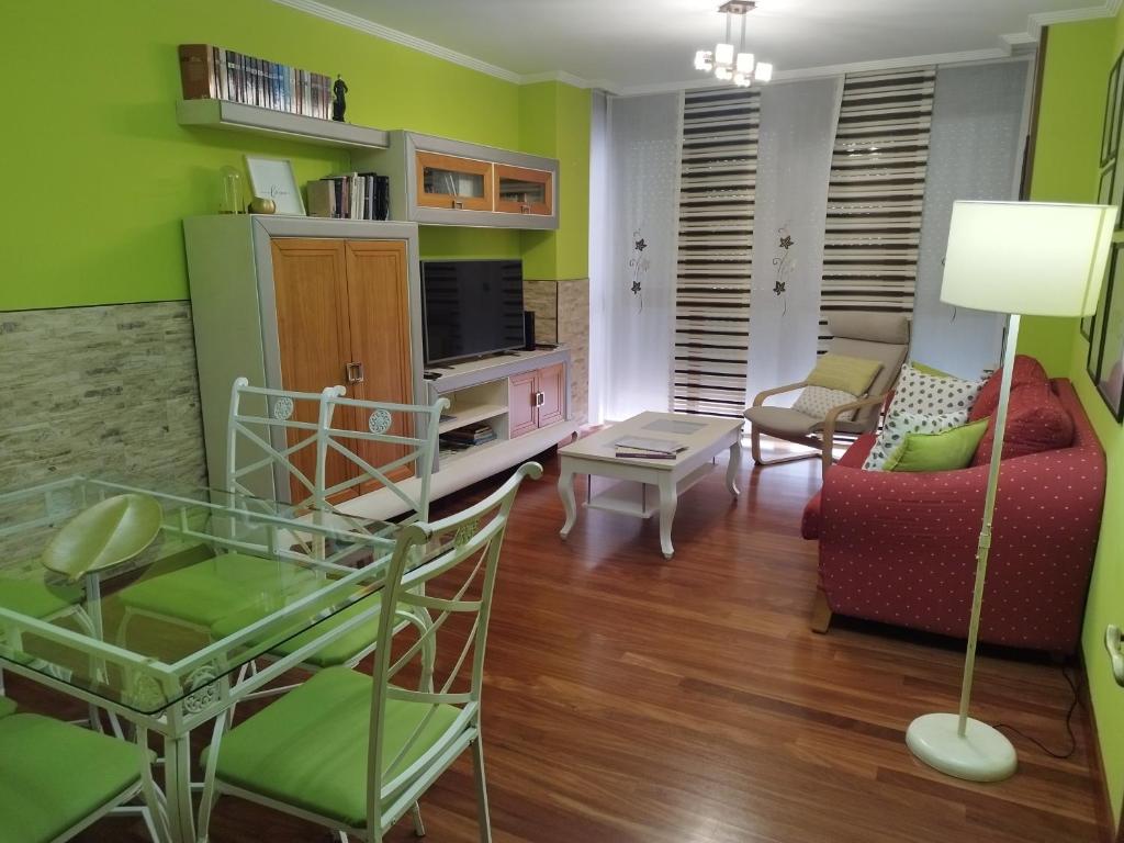 a living room with green walls and a couch at Apartamento El Ferial in Sarón