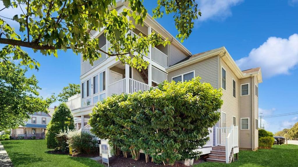 a house with a tree in front of it at Rehoboth Beach - 24 Brooklyn Ave Unit E in Rehoboth Beach