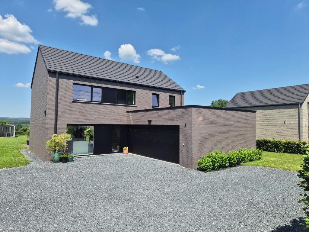 a large brick house with a garage at Villa de l'Eau Rouge in Malmedy