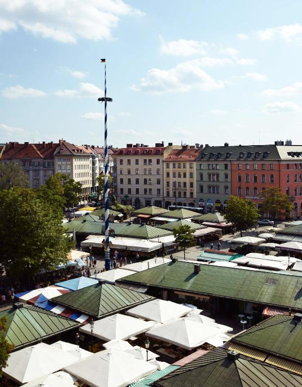 an overhead view of a city with buildings and roofs at Louis Hotel in Munich