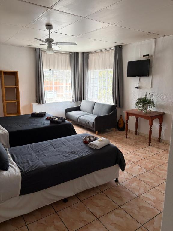 a living room with two beds and a couch at Formule 11 in Frankfort