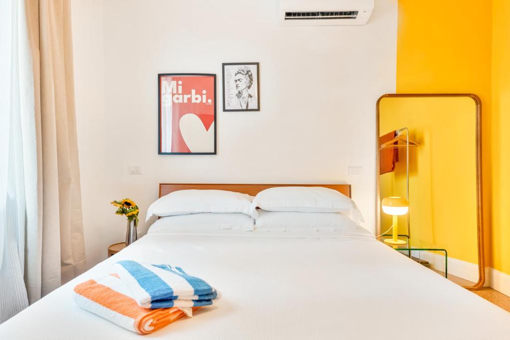 a bedroom with a bed with two towels on it at CasaMichelin in Marina di Massa