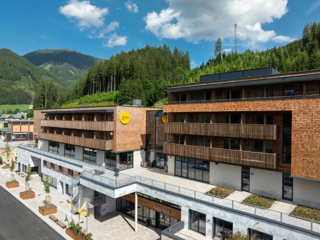 an aerial view of a building with mountains in the background at JUFA Hotel Werfenweng in Werfenweng