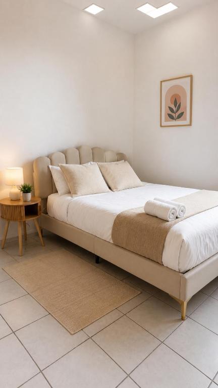 a bedroom with a large bed with a table at Romantic Suite with Private Jacuzzi in Noyon