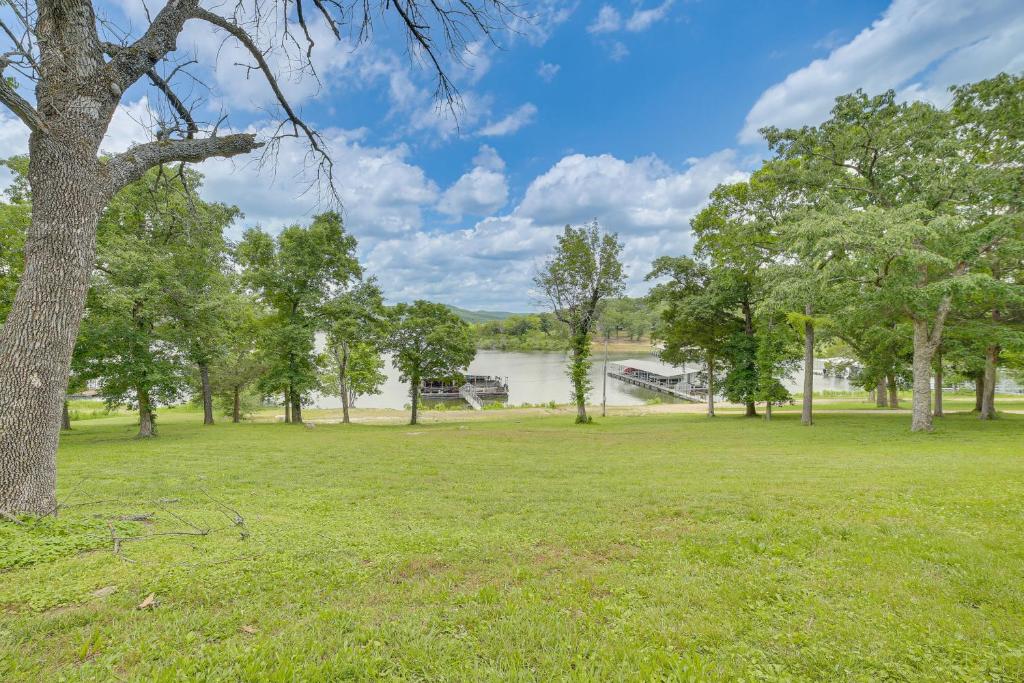 a park with a lake and a tree at Lakeside Reeds Spring Home w/ Deck & Pool Access! in Reeds Spring