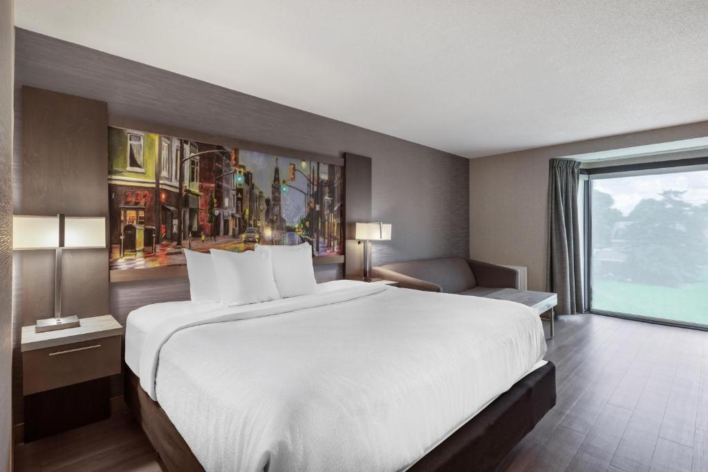 a hotel room with a large bed and a window at Best Western Belleville in Belleville