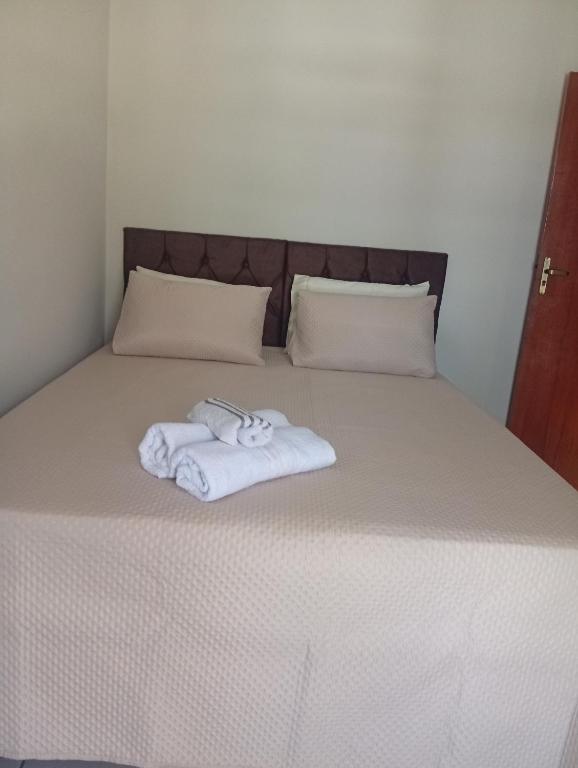 a bedroom with a bed with two towels on it at Veneza Exclusive 101 in Ipatinga