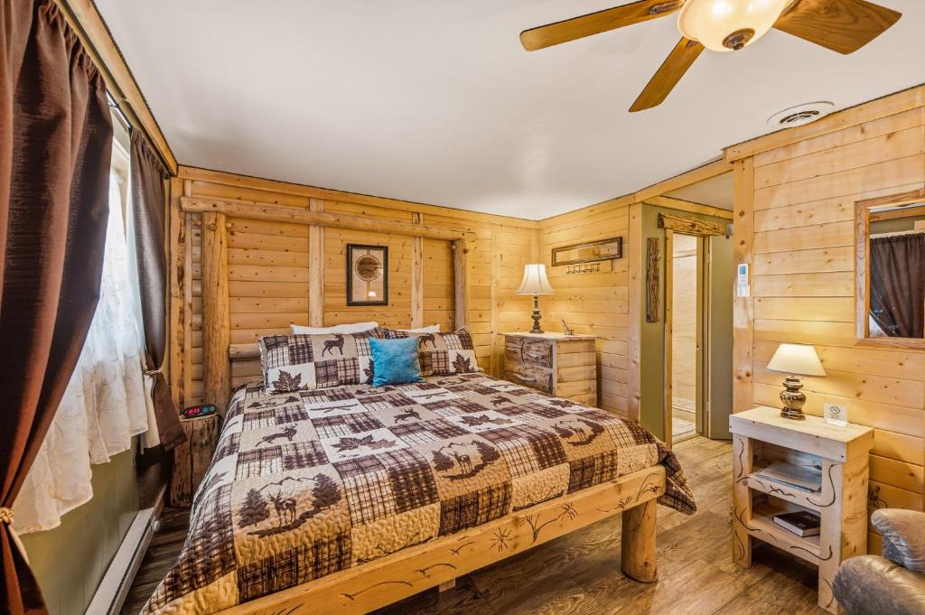a bedroom with a bed and a ceiling fan at Basecamp 2 at the Cedaredge Lodge in Cedaredge