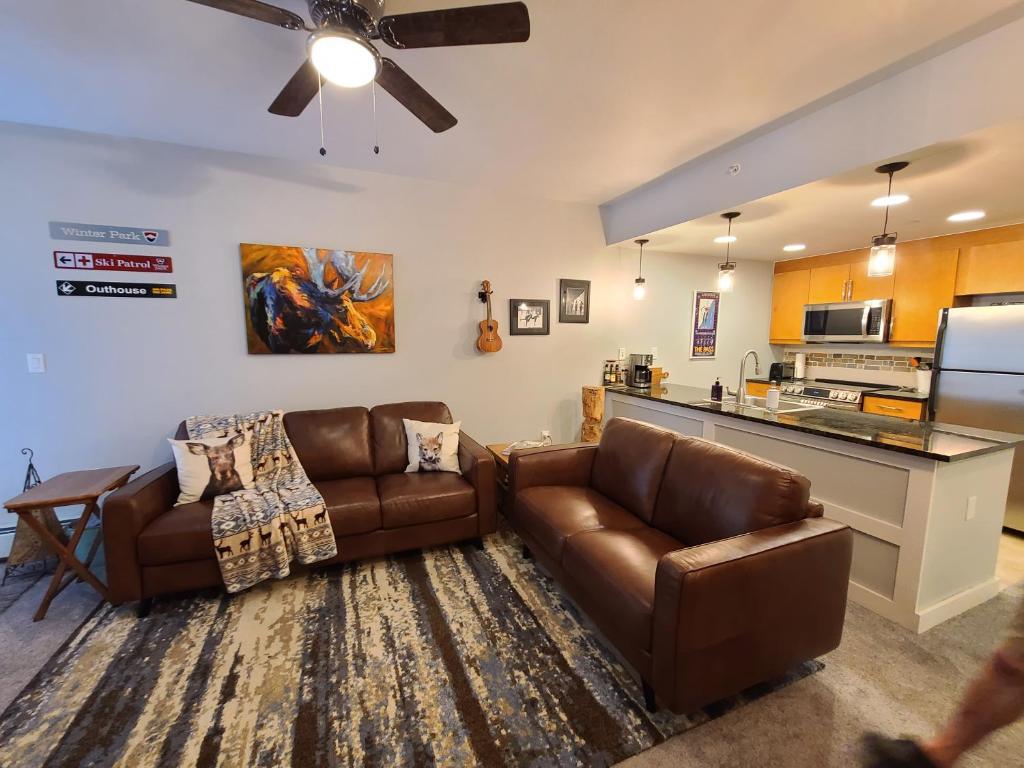 a living room with two couches and a kitchen at Fraser Crossing 3417 in Winter Park