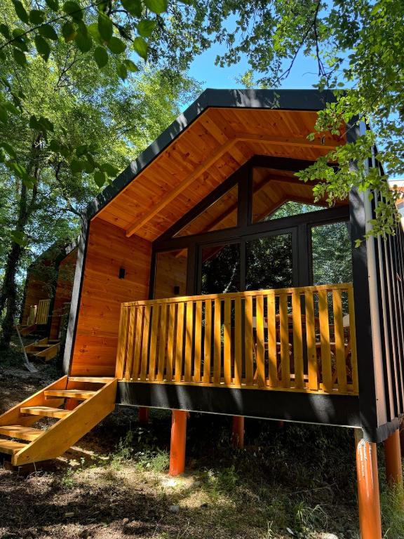 a small wooden cabin with a wooden deck at BetosGarden in Ulcinj