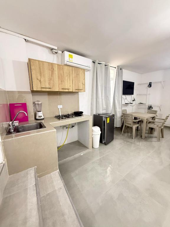 a kitchen with a sink and a table at Caribe 102-1 in San Andrés