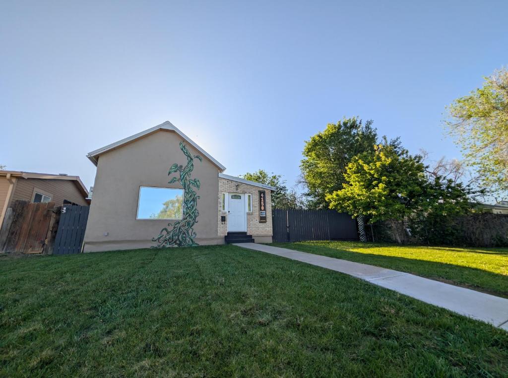 a house with a fence and a grass yard at Denver Oasis 5BR Home with Hot Tub, Sleeps 16 in Denver