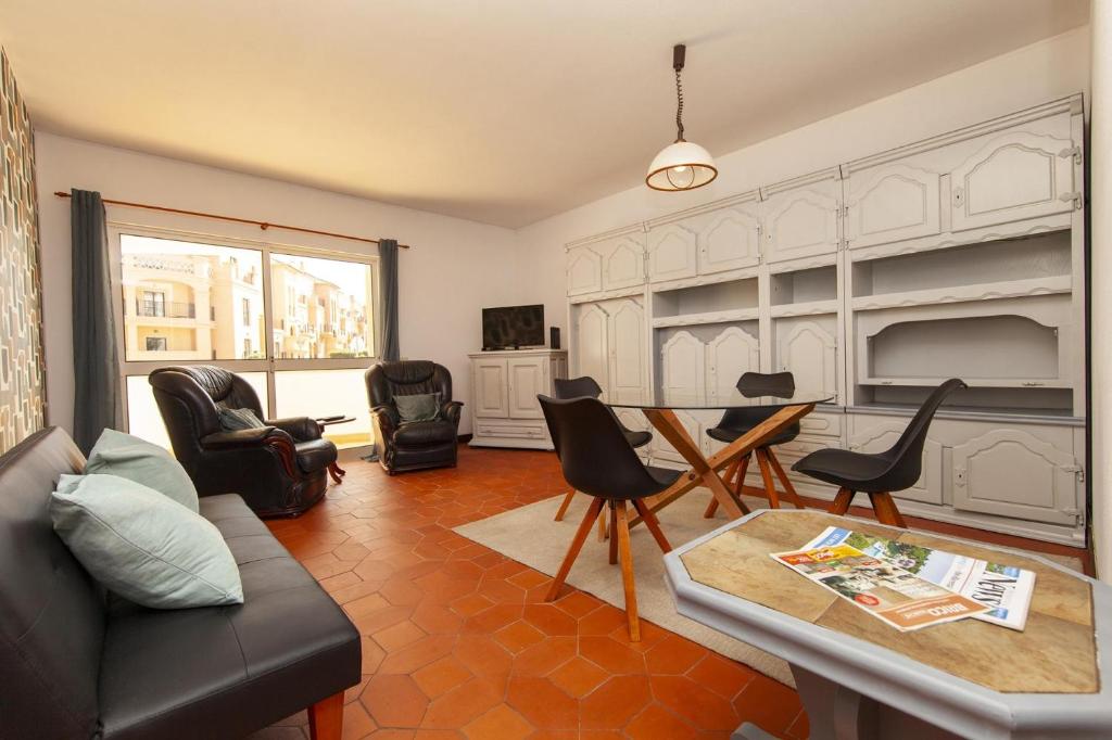 a living room with a couch and chairs and a table at Praia da Luz Coast Flat in Luz