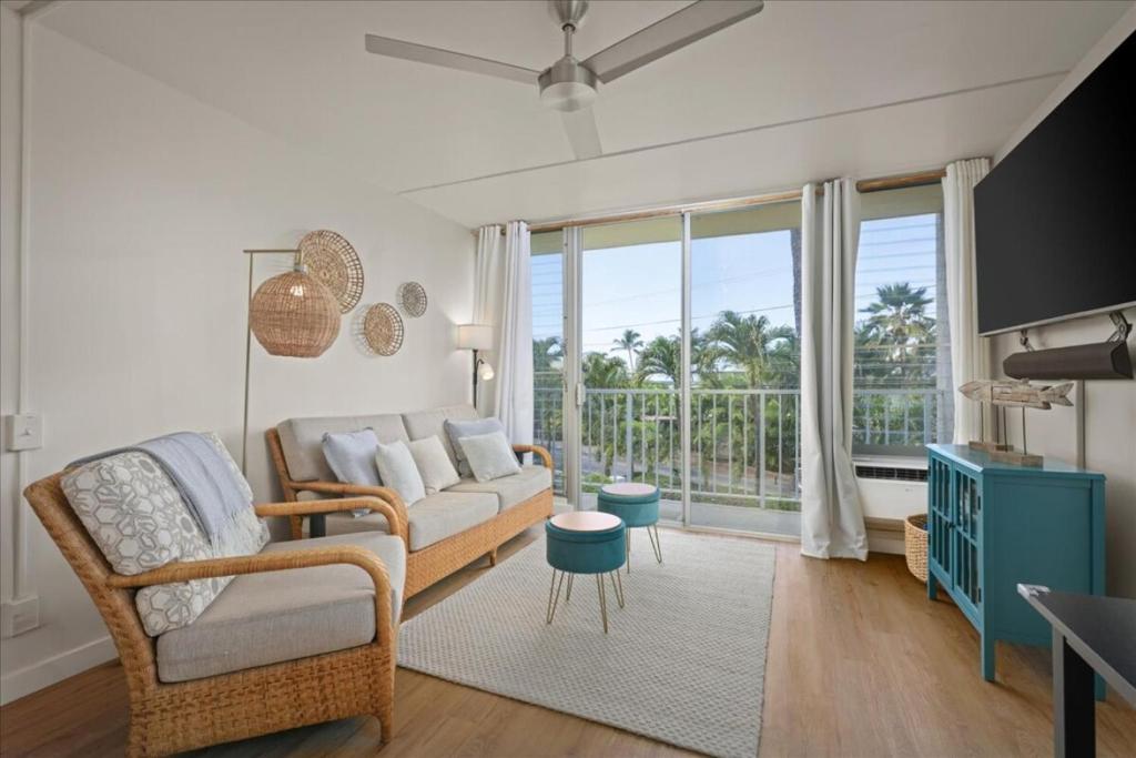 a living room with a couch and a large window at Puako Beach Condo 210 - 3 Bedrooms in Waikoloa