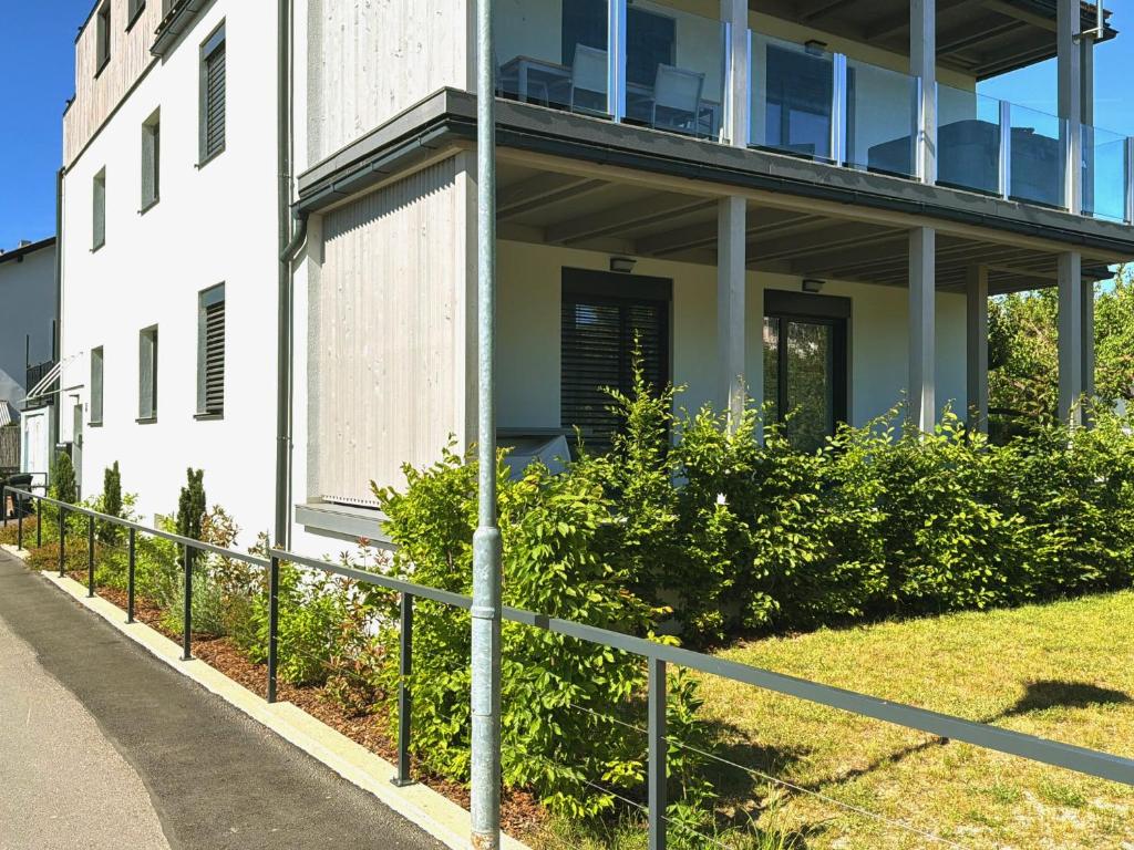 a white building with a fence in front of it at Riverside Furth in Furth