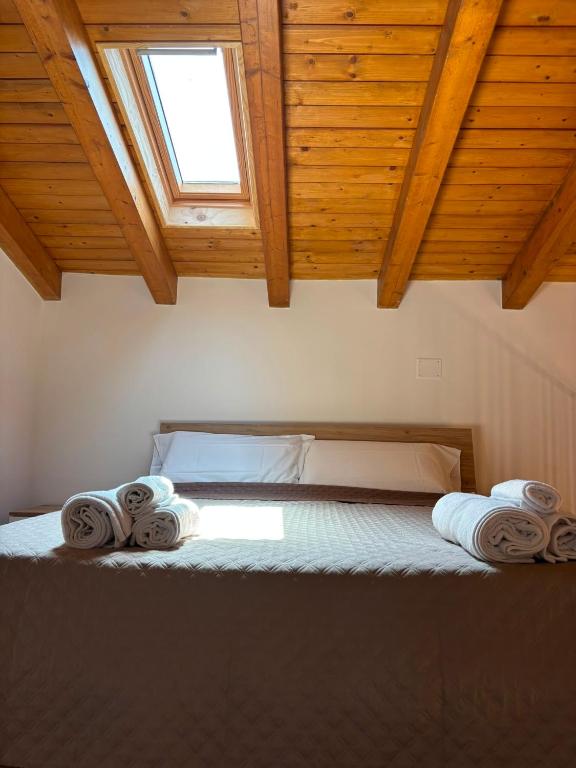 a bedroom with a bed with towels on it at Amarè House in Catania