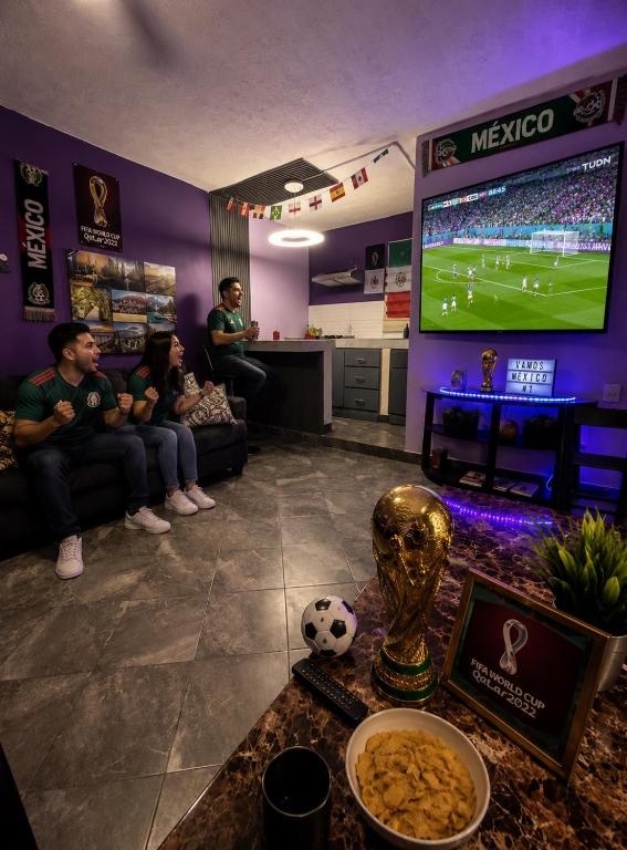 a group of people sitting in a room with a tv at Departamento Mateos 501 in Ciudad Acuña