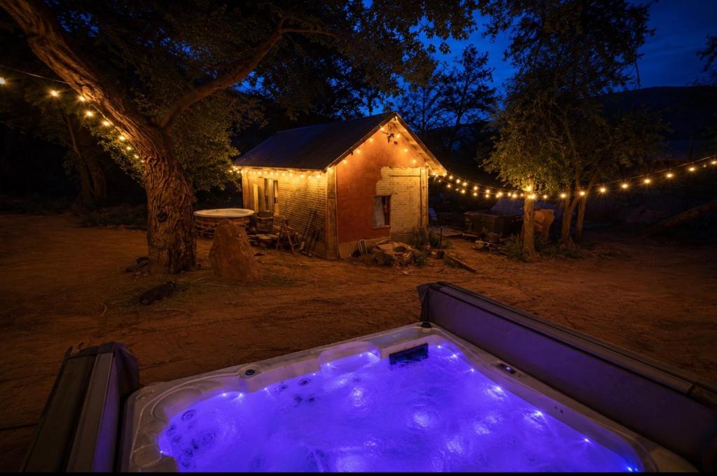 a hot tub in front of a house at night at Kit Inn Wetrock in Moab