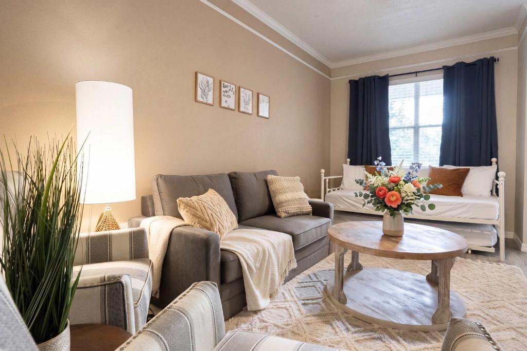 a living room with a couch and a table at Stylish Sanctuary King Beds Upscale Condo in Gainesville
