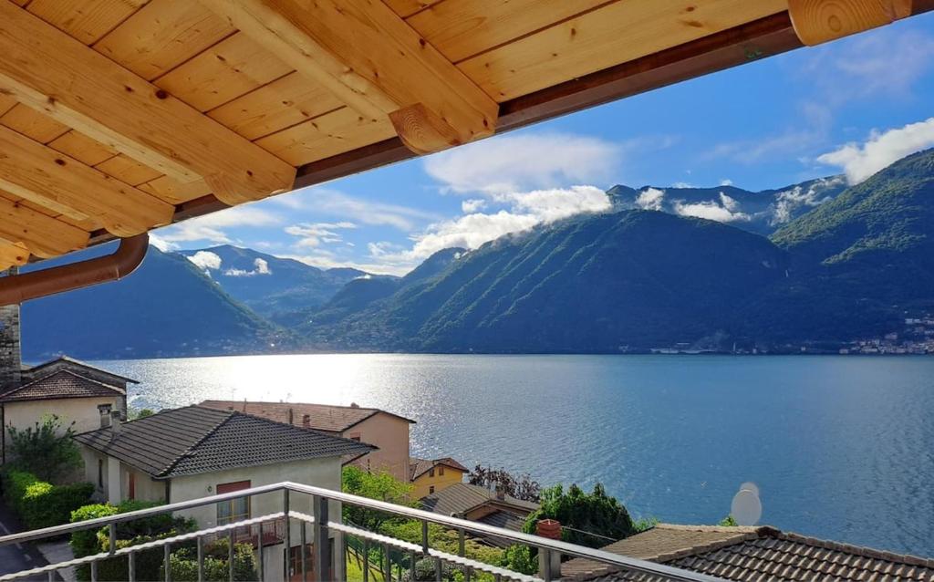 a view of a lake and mountains from a balcony at Panoramic and view apartments in Lezzeno