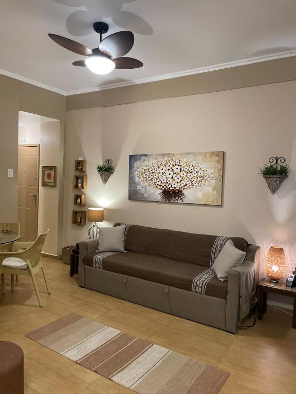 a living room with a couch and a ceiling fan at BeM Ipanema in Rio de Janeiro