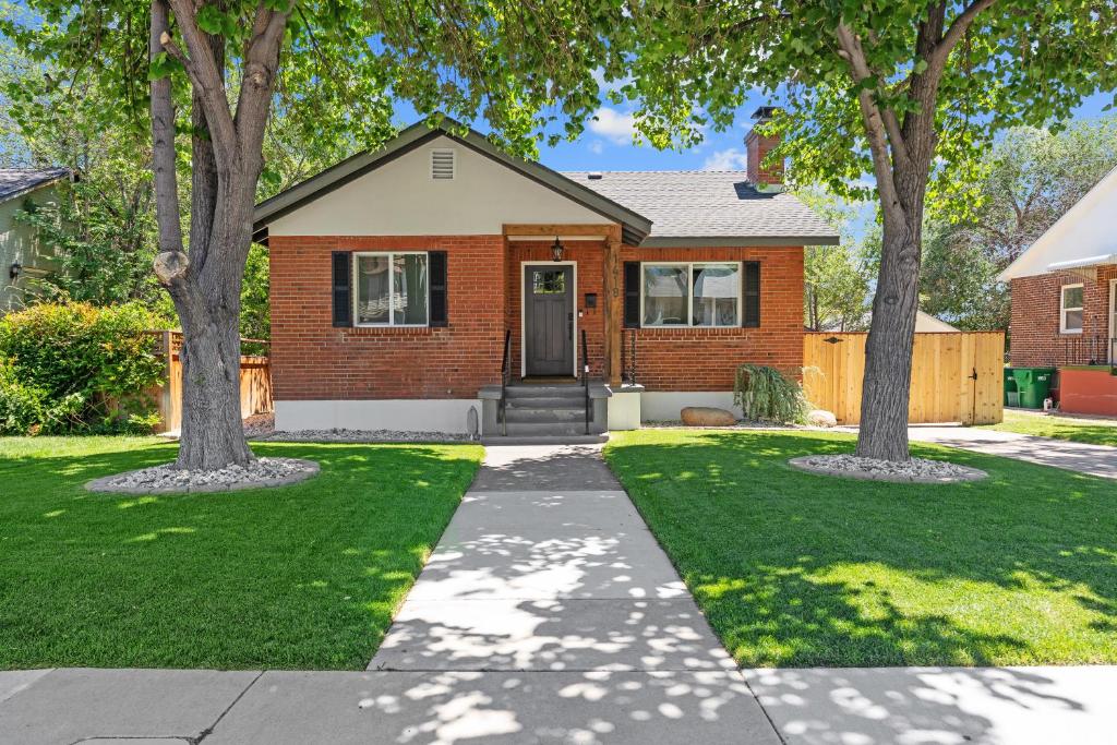 a brick house with trees in the front yard at Charming house in Midtown District in Reno