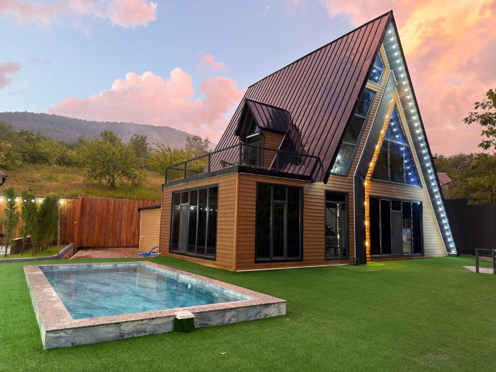 a house with a swimming pool in a yard at Bungalov Azerbaijan in Vǝndam