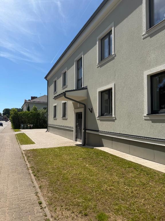 a gray building with a door on the side of it at Otepää city view apartment in Otepää