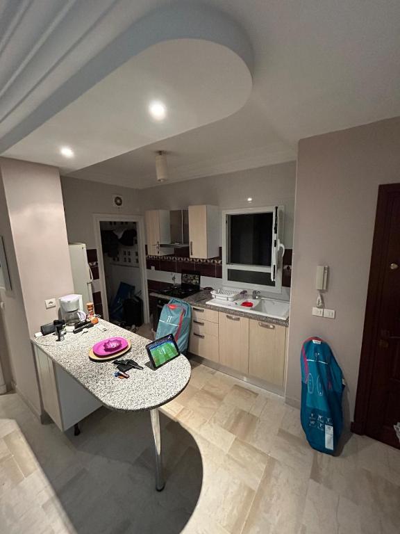 a large kitchen with a table in a room at Cozy One Bedroom Apartment in Nabeul