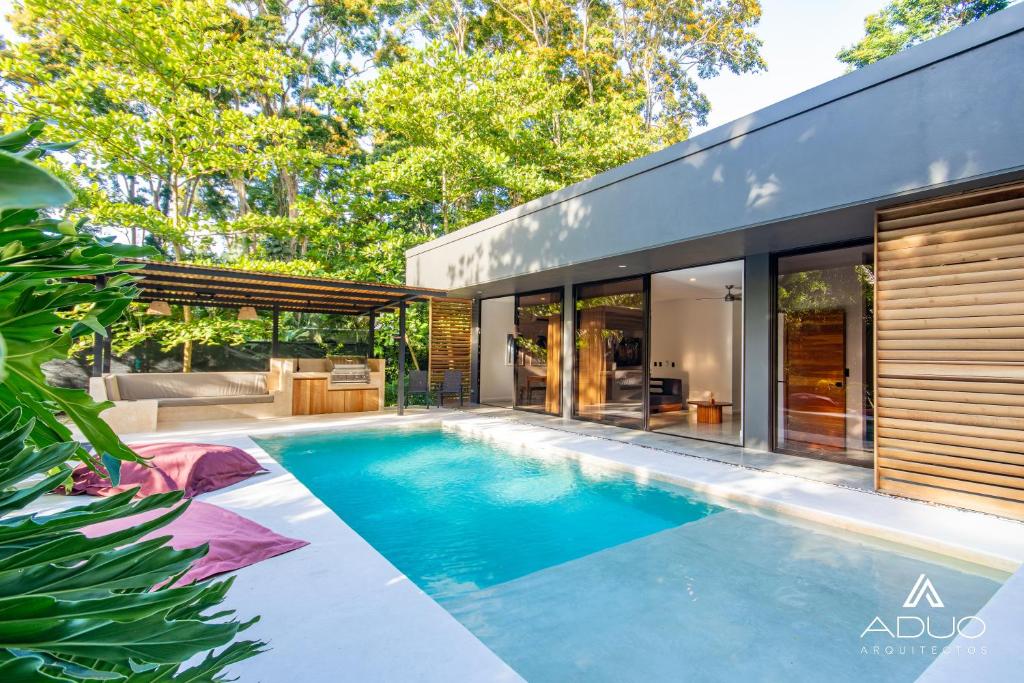 a swimming pool in the backyard of a house at Private Jungle House No1Calalu with AC, Pool & EV in Talamanca