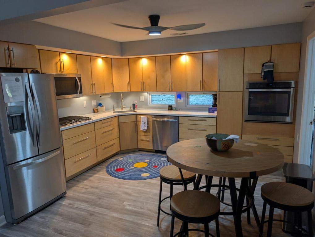 a kitchen with a table and chairs and a refrigerator at Otterspace at the beach in Shady Side
