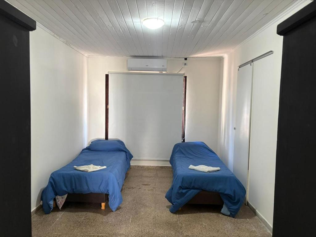 a room with two beds in a room with a ceiling at 9 De Julio in Charata