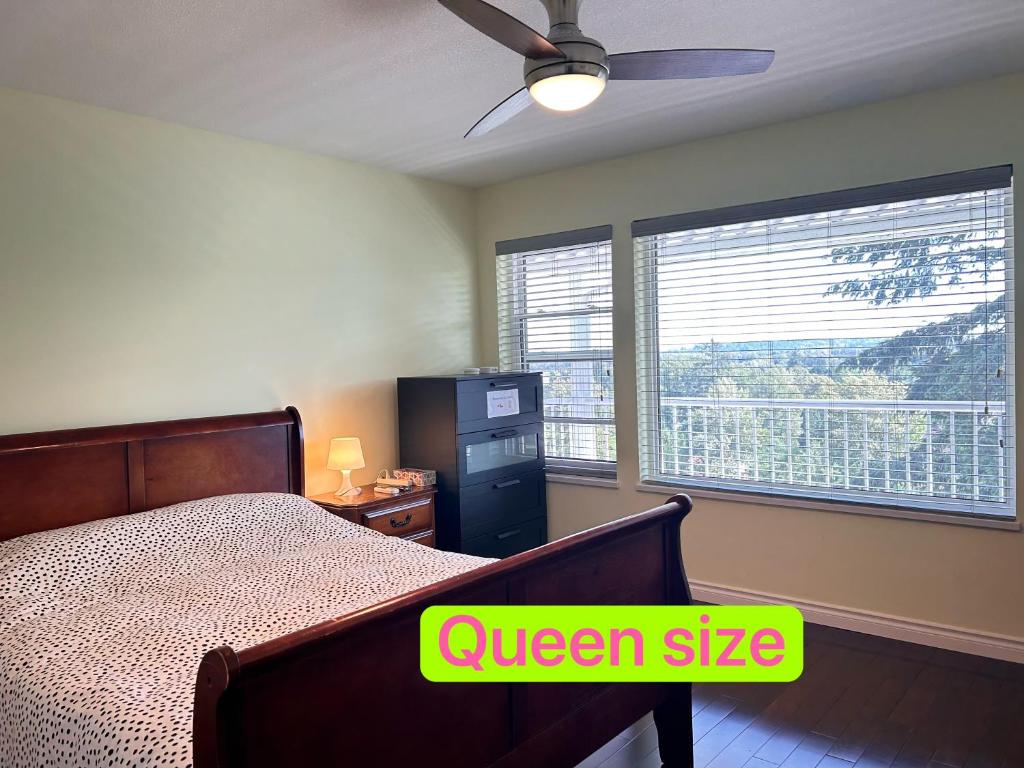 a bedroom with a queen size bed and a window at Sandy's Sweet Home in Coquitlam