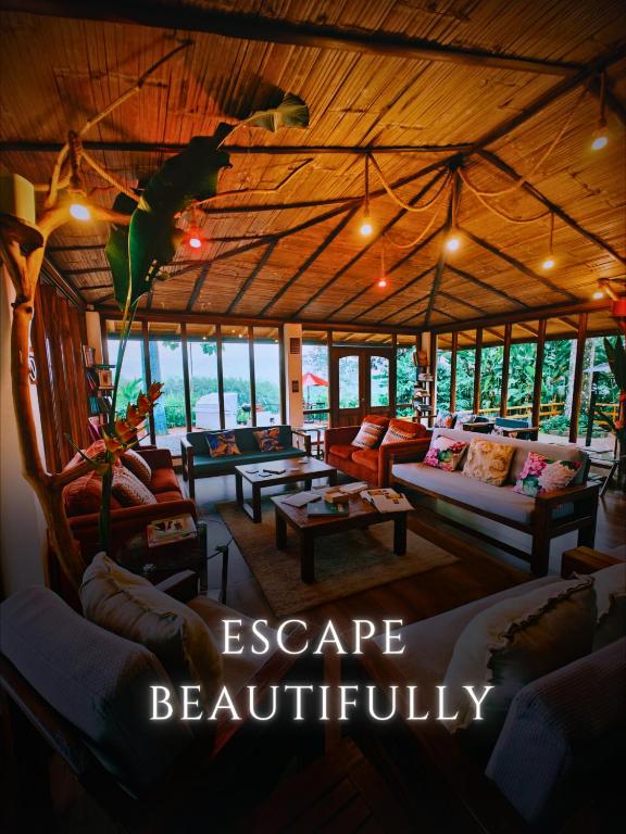 a large living room with couches and tables at The River House in Puerto Quito