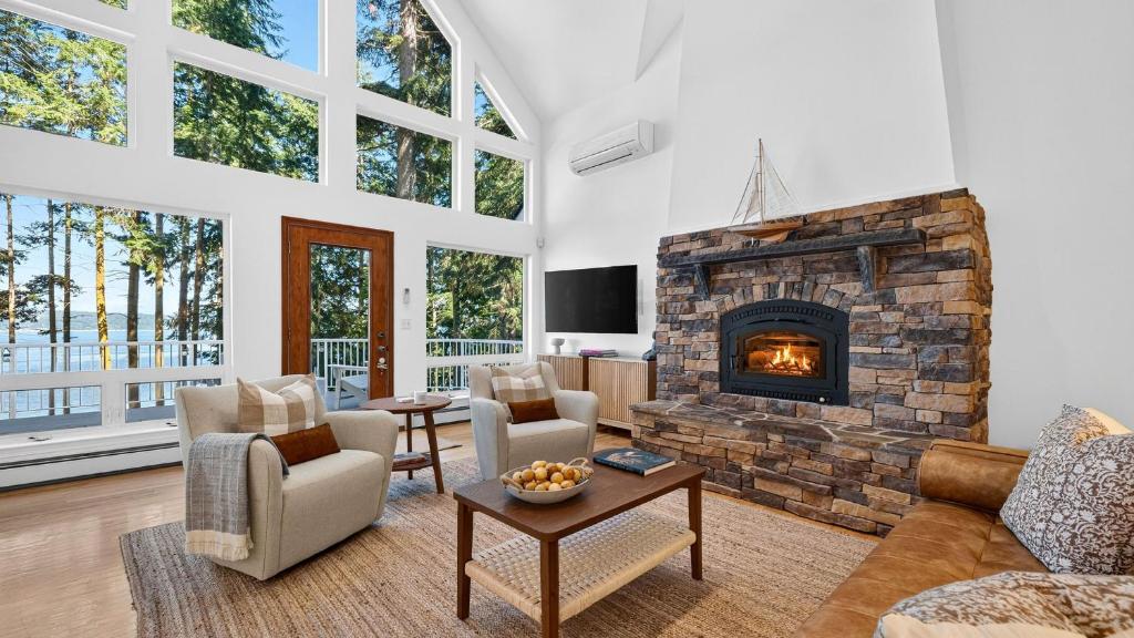 a large living room with a stone fireplace at Eagles Bluff by AvantStay in Greenbank