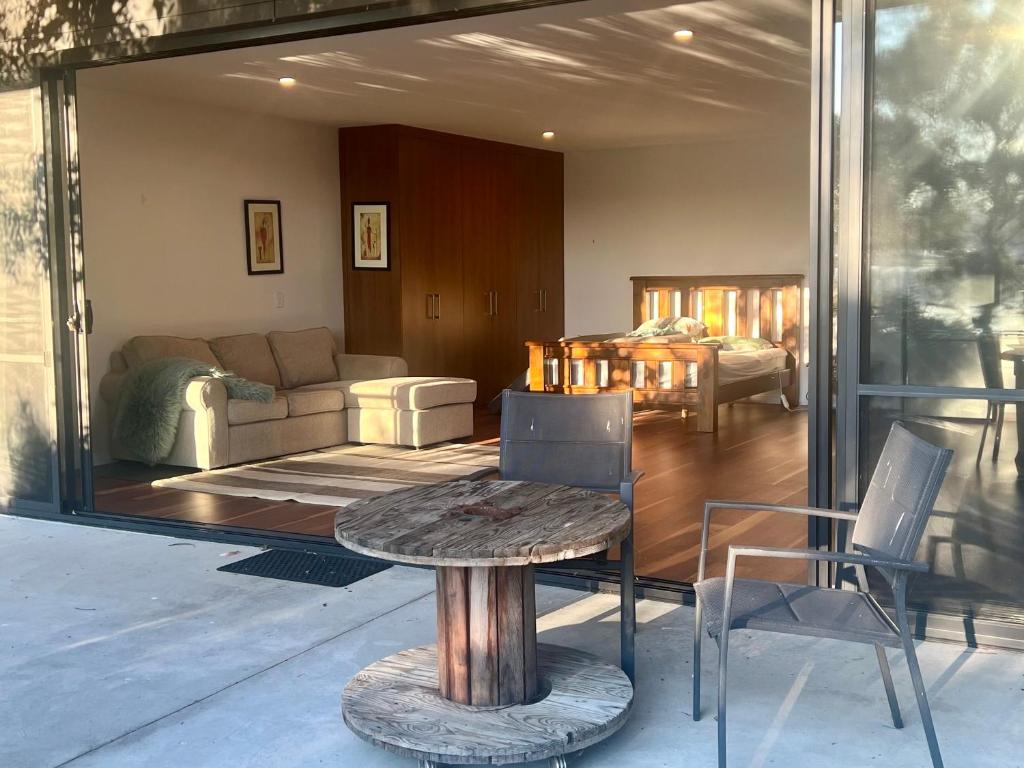 a living room with a table and a couch at Your SHACK by the water in Sorell