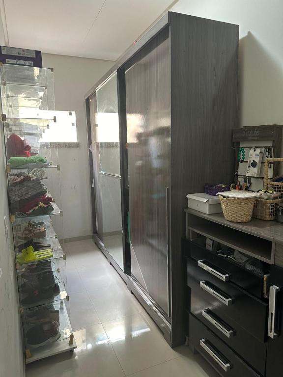 a kitchen with a stainless steel refrigerator in a room at Casa para Pedrão in Eunápolis