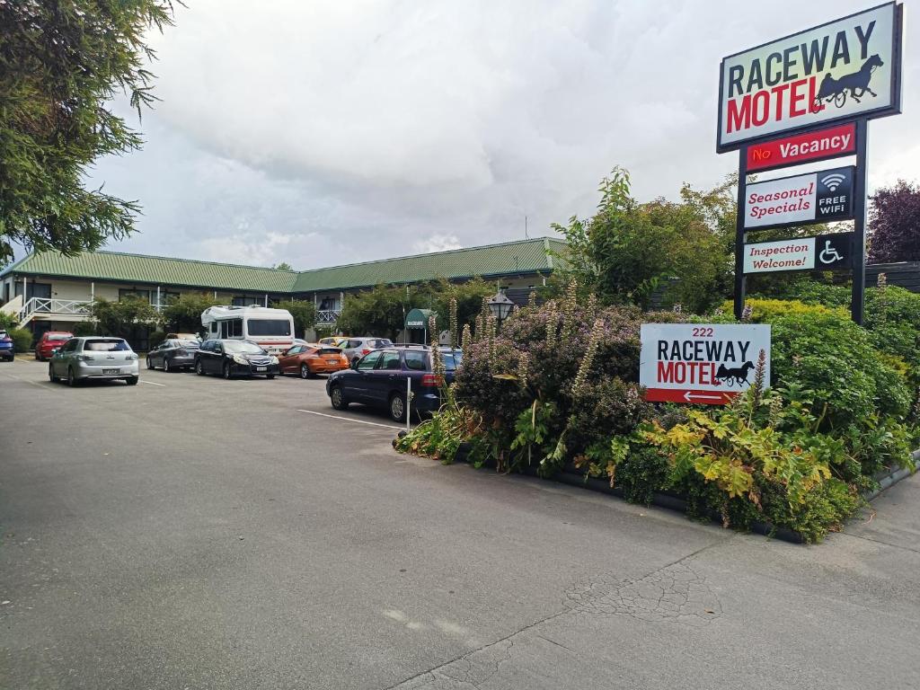 a parking lot with cars parked in front of a motel at Raceway Motel in Christchurch