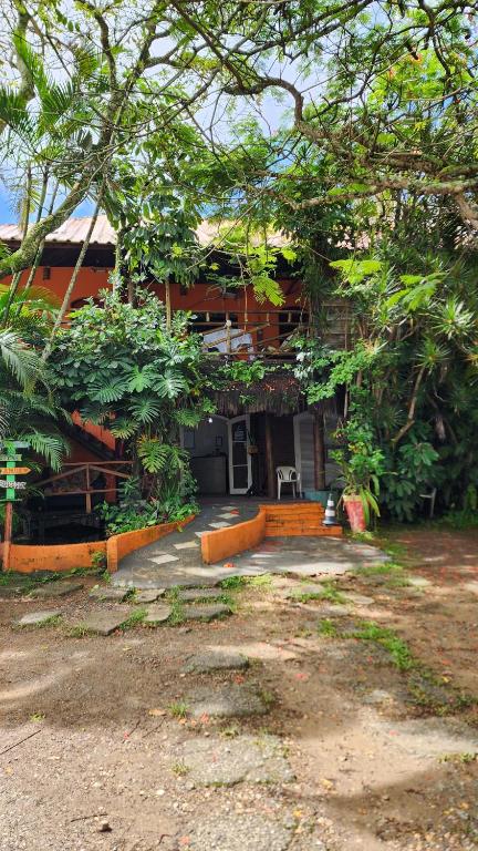 a house with a lot of trees in front of it at Pousada Morada do Tombo in Guarujá