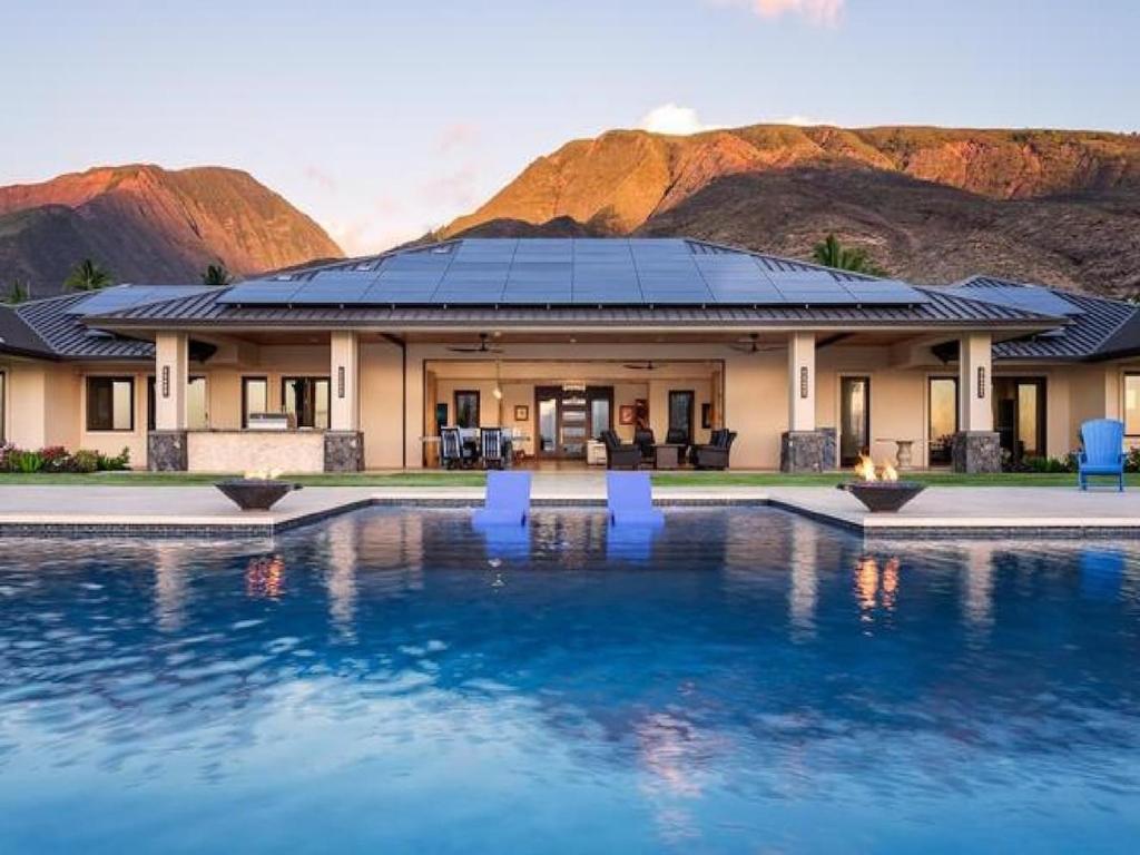 a house with a swimming pool in front of a mountain at Villa with pool extraordinary view in Lahaina in Lahaina