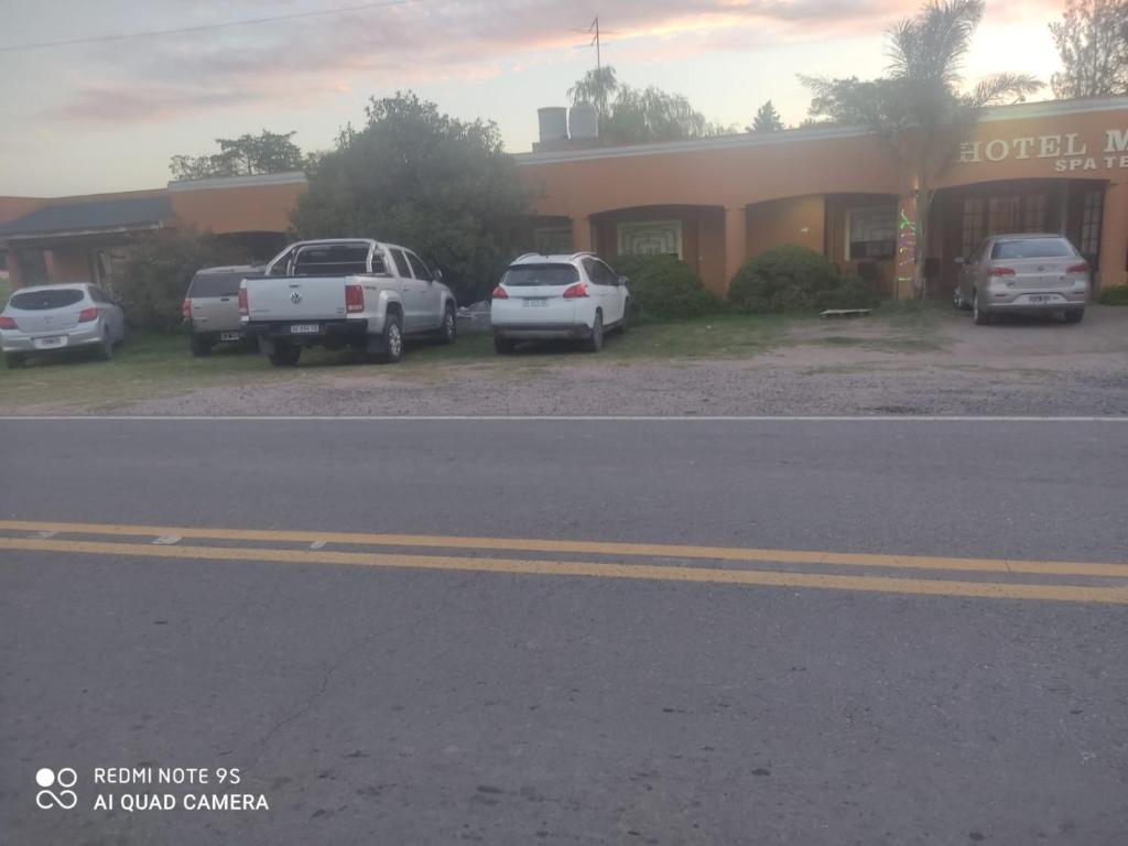 a group of cars parked in front of a building at Hotel Mirage Spa in Carhué